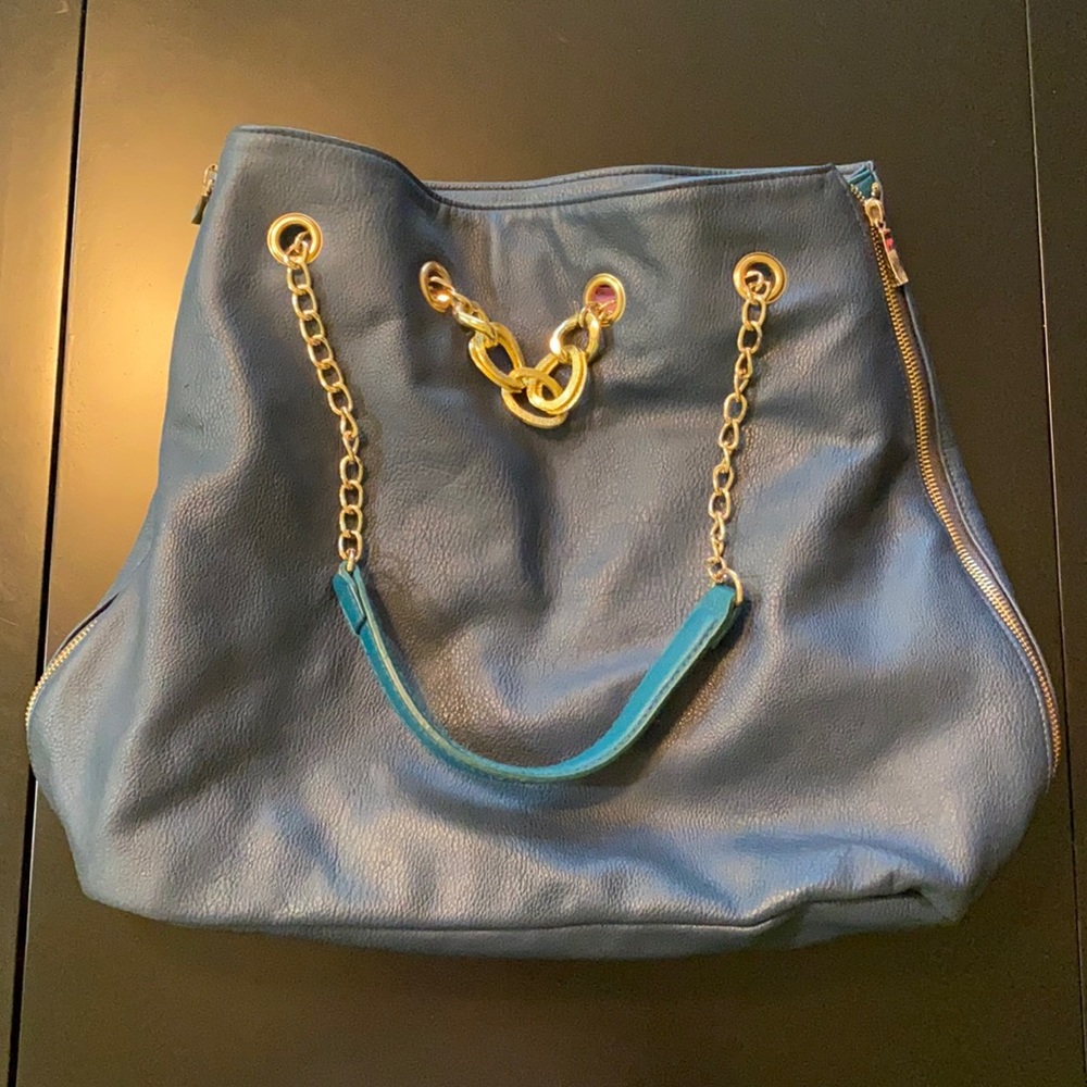 Blue purse, zipper both sides reveals teal insert.